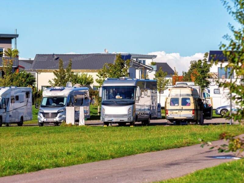 Im Vordergrund Grünflächen, dahinter ist der Wohnmobilstellplatz von Horgenzell zu sehen, auf welchem einige Wohnmobile parken.